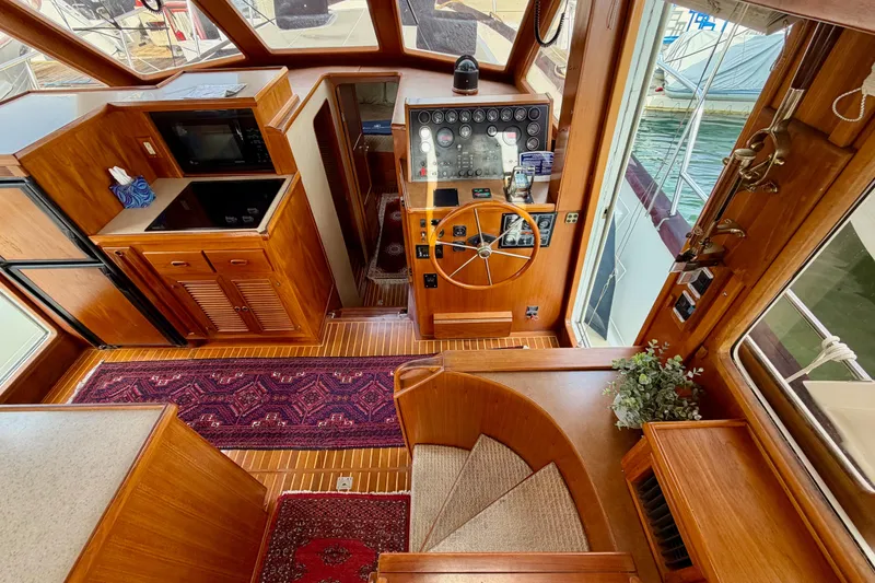 Slide: The Image of Interior of 1988 Offshore Yachts 48 Sedan with wooden cabinetry and helm station. - 44