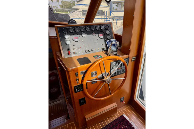 Slide: The Image of Helm of 1988 Offshore Yachts 48 Sedan with wooden wheel and control panel. - 46