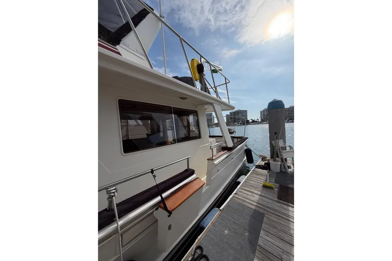 Slide: The Image of 1988 Offshore Yachts 48 Sedan docked, showcasing sleek design and waterfront view. - 5