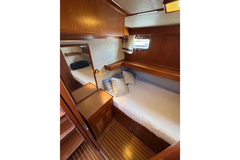 Slide: The Image of Cozy cabin interior of 1988 Offshore Yachts 48 Sedan with wood finish and bedding. - 59
