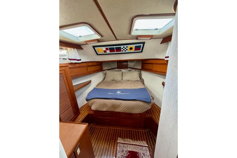 Slide: The Image of Cozy cabin interior of 1988 Offshore Yachts 48 Sedan with bed and nautical decor. - 64
