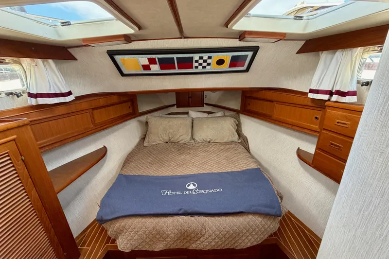 Slide: The Image of Cozy cabin interior of 1988 Offshore Yachts 48 Sedan with nautical decor and skylights. - 65