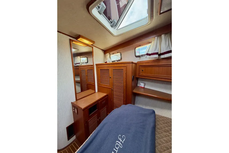 Slide: The Image of Interior of 1988 Offshore Yachts 48 Sedan, featuring wood cabinetry and skylight. - 67