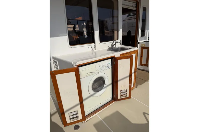 Slide: The Image of Laundry area with washing machine and sink on 1988 Offshore Yachts 48 Sedan. - 20