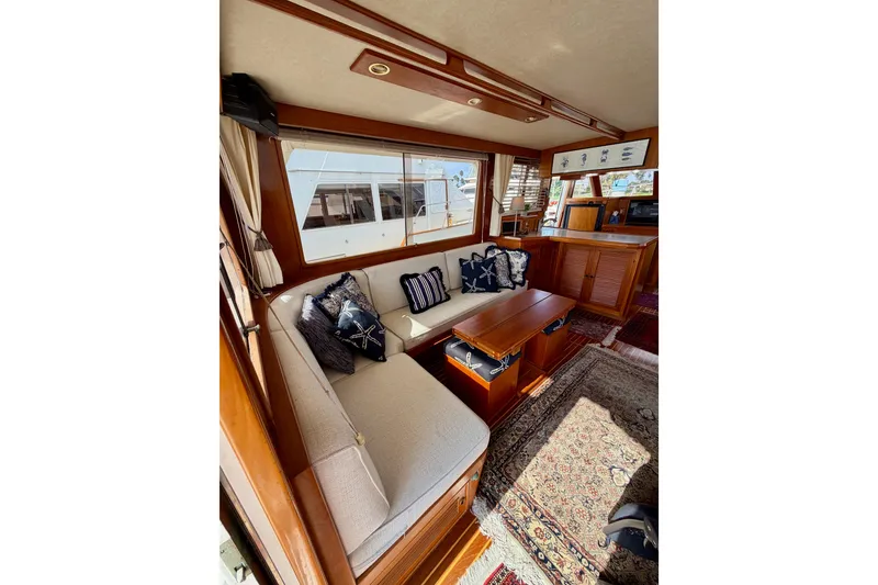 Slide: The Image of Interior of 1988 Offshore Yachts 48 Sedan with cozy seating and nautical decor. - 23