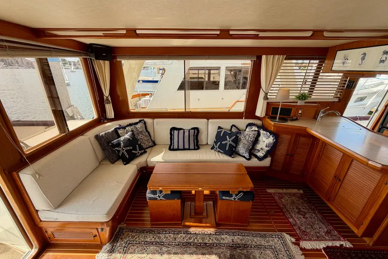 Slide: The Image of Luxurious interior of 1988 Offshore Yachts 48 Sedan with elegant seating and nautical decor. - 24