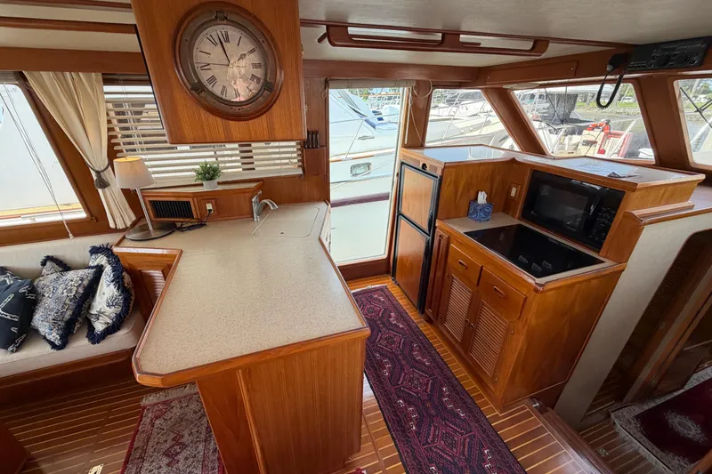 Slide: The Image of Interior of 1988 Offshore Yachts 48 Sedan with kitchen and seating area. - 29