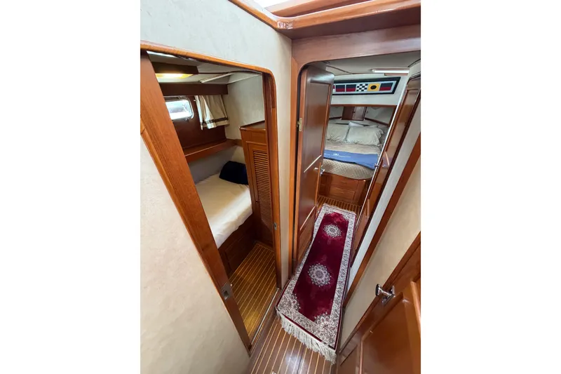 Slide: The Image of Interior of 1988 Offshore Yachts 48 Sedan, featuring cozy cabins and elegant wood finishes. - 57