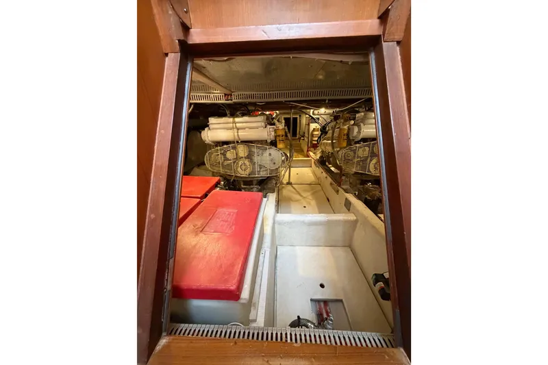 Slide: The Image of Engine room of 1988 Offshore Yachts 48 Sedan, showcasing mechanical components and storage. - 73