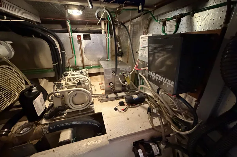 Slide: The Image of Engine room of 1988 Offshore Yachts 48 Sedan with mechanical and electrical components. - 75