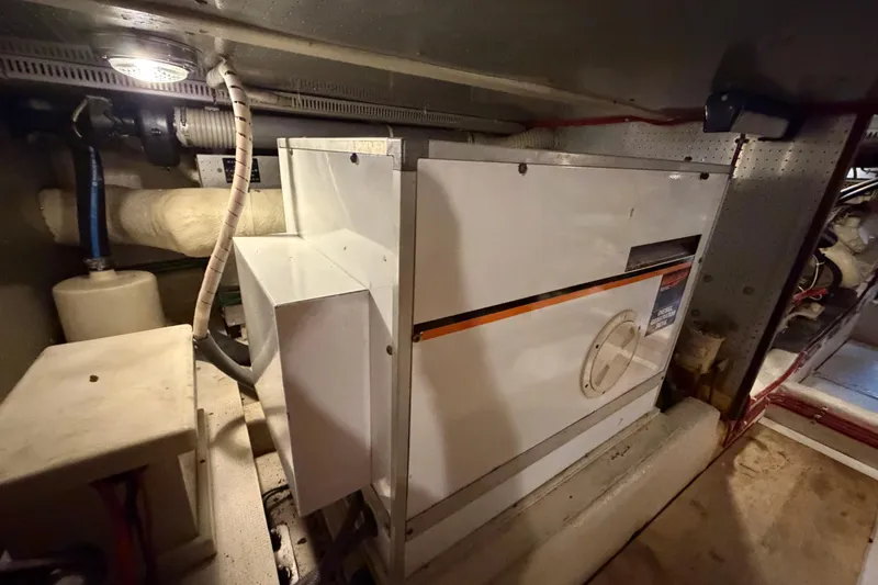 Slide: The Image of Engine room of 1988 Offshore Yachts 48 Sedan, showcasing machinery and equipment. - 85