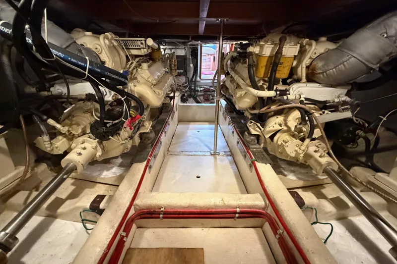Slide: The Image of Engine room of 1988 Offshore Yachts 48 Sedan, showcasing dual engines and mechanical components. - 86