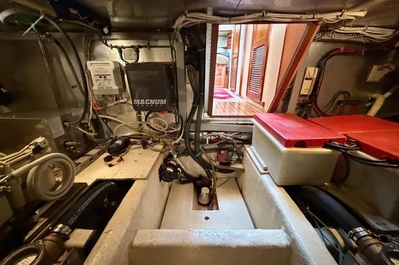 Slide: The Image of Engine room of 1988 Offshore Yachts 48 Sedan, showcasing wiring and equipment. - 87