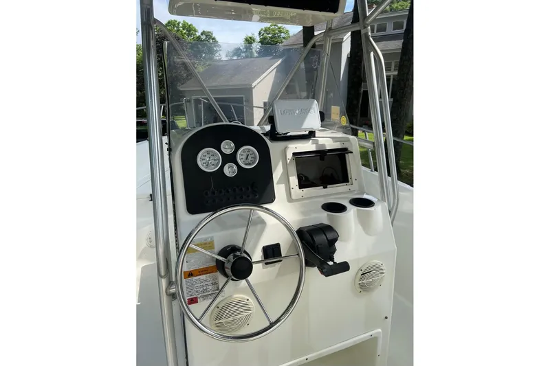 Slide: The Image of 2001 Hydra-Sports 230 Seahorse CC boat console with steering wheel and gauges. - 2