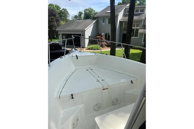 Slide: The Image of 2001 Hydra-Sports 230 Seahorse CC boat docked near a modern house. - 3