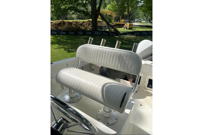 Slide: The Image of 2001 Hydra-Sports 230 Seahorse CC boat with white cushioned seating and rod holders. - 5