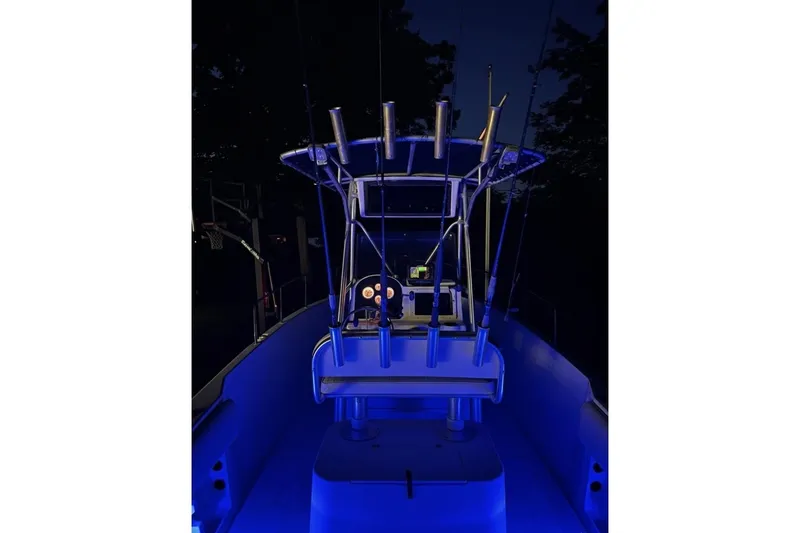 Slide: The Image of 2001 Hydra-Sports 230 Seahorse CC boat illuminated with blue lights at night. - 7