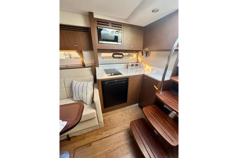 Slide: The Image of Interior of 2021 Sea Ray Sundancer 350 yacht, featuring a modern kitchen and seating area. - 10