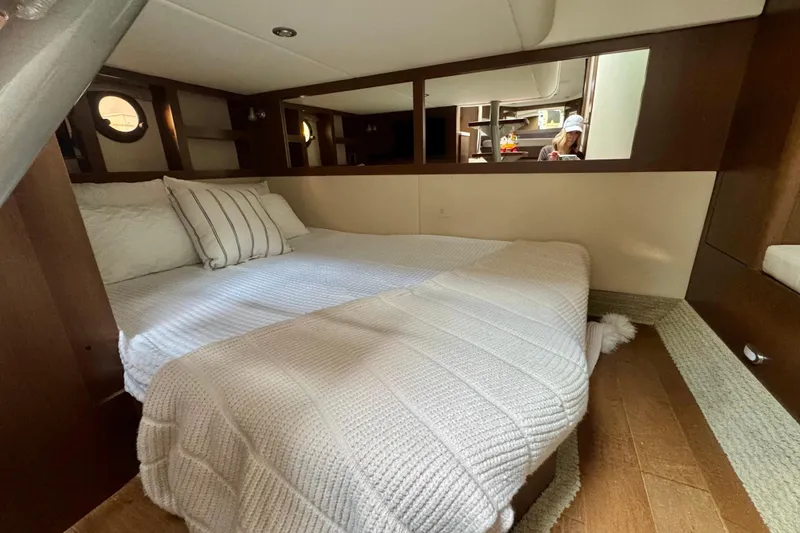 Slide: The Image of 2021 Sea Ray Sundancer 350 cabin interior with cozy bed and modern design. - 12
