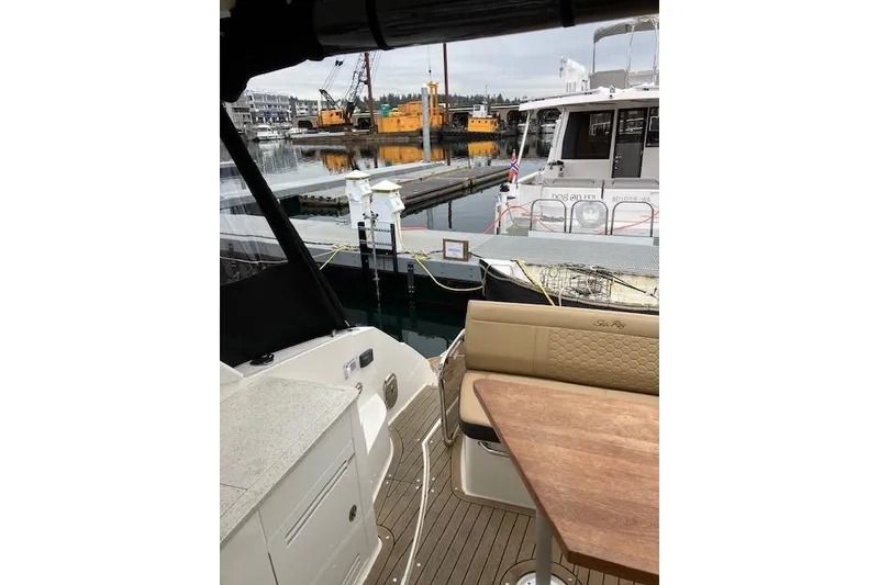 Slide: The Image of 2021 Sea Ray Sundancer 350 interior with dock view, featuring seating and table. - 17