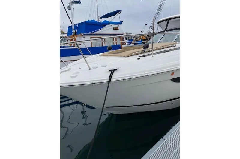 Slide: The Image of 2021 Sea Ray Sundancer 350 docked at marina, featuring sleek white design. - 18