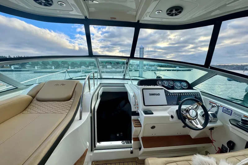 Slide: The Image of 2021 Sea Ray Sundancer 350 helm with luxurious seating and advanced navigation system. - 24