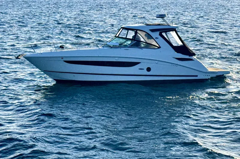 Slide: The Image of 2021 Sea Ray Sundancer 350 yacht cruising on open water. - 28