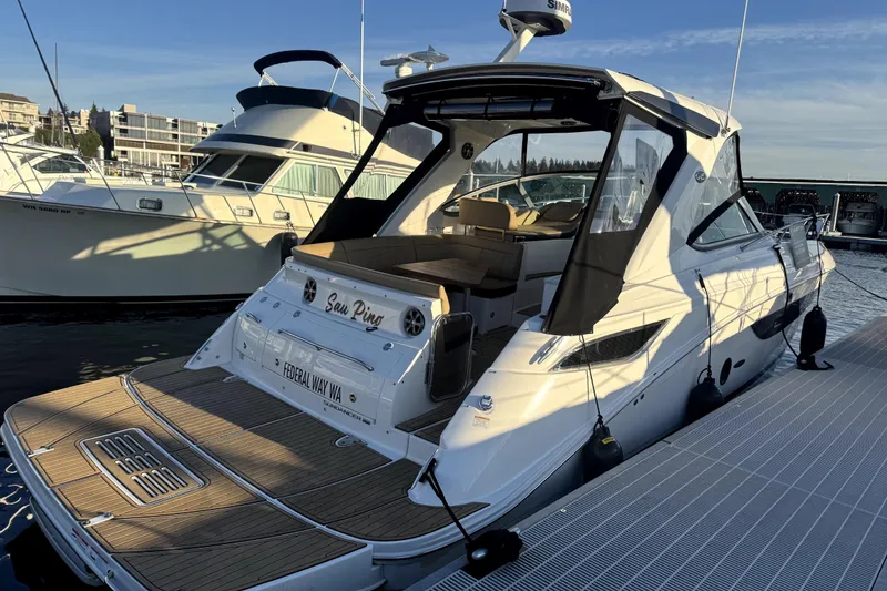 Slide: The Image of 2021 Sea Ray Sundancer 350 docked at marina, rear view with open cockpit. - 30