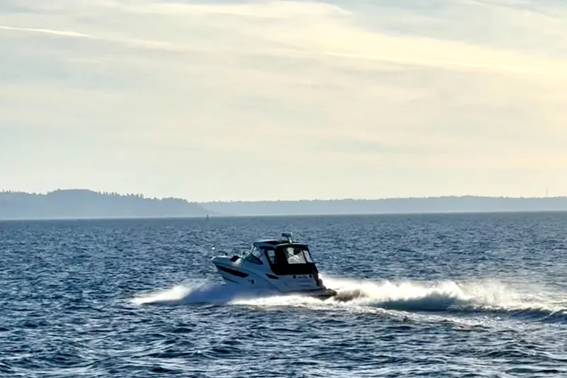Slide: The Image of 2021 Sea Ray Sundancer 350 cruising on open water under a clear sky. - 39