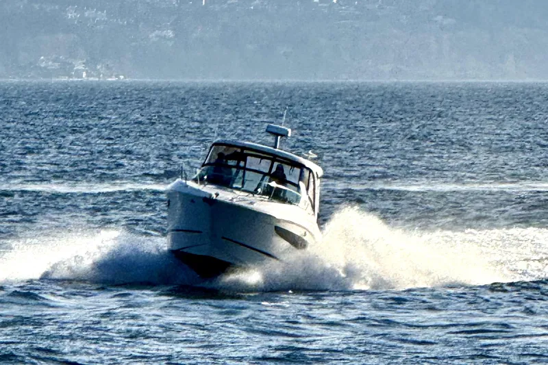 Slide: The Image of 2021 Sea Ray Sundancer 350 cruising on open water, creating a dynamic splash. - 41
