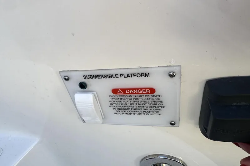 Slide: The Image of 2021 Sea Ray Sundancer 350 submersible platform warning sign with safety instructions. - 43