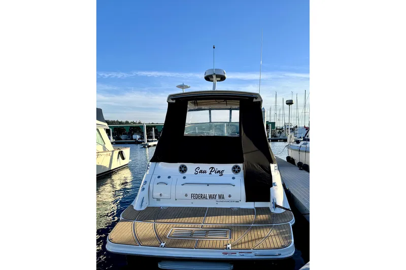 Slide: The Image of 2021 Sea Ray Sundancer 350 docked at marina, rear view with black cover. - 46