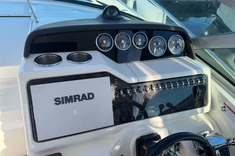 Slide: The Image of 2021 Sea Ray Sundancer 350 dashboard with Simrad navigation system and gauges. - 5