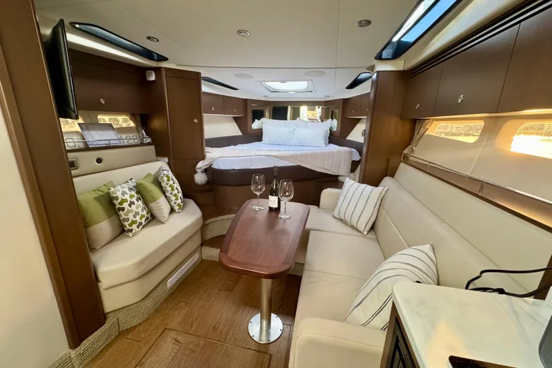 Slide: The Image of Luxurious interior of 2021 Sea Ray Sundancer 350 yacht with elegant seating and bedding. - 7
