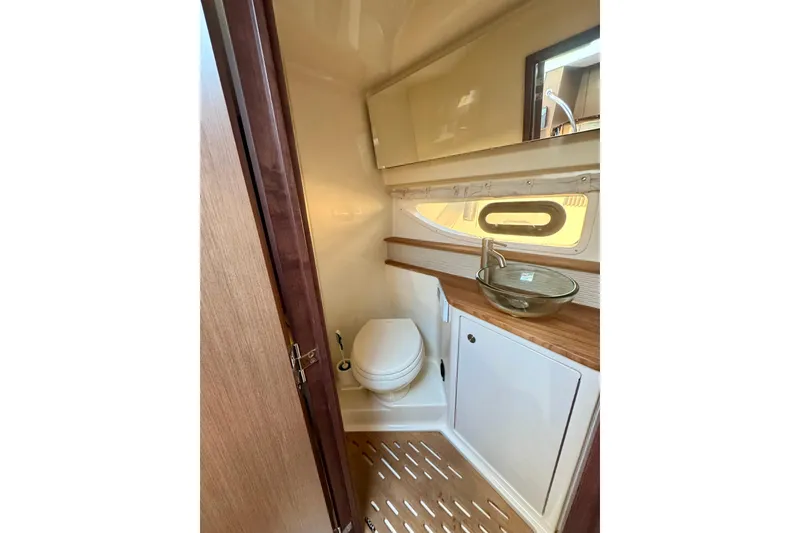 Slide: The Image of 2021 Sea Ray Sundancer 350 bathroom with modern sink and toilet. - 8