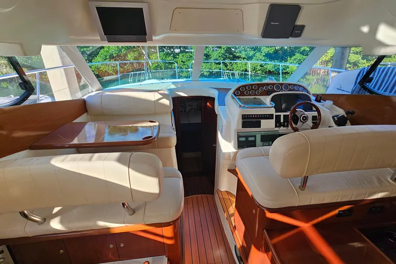 Slide: The Image of 2005 Prestige 46 yacht deck with seating and wooden flooring. - 15
