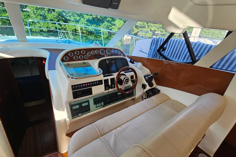 Slide: The Image of Luxury 2005 Prestige 46 yacht with elegant wooden deck and spiral staircase. - 16