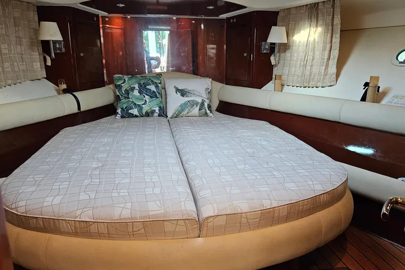 Slide: The Image of Luxurious 2005 Prestige 46 yacht kitchen with stove, sink, microwave, and wooden flooring. - 27
