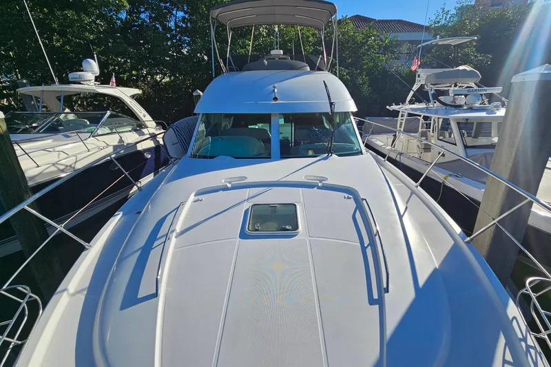 Slide: The Image of 2005 Prestige 46 yacht cruising near waterfront buildings and palm trees. - 6