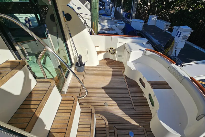 Slide: The Image of 2005 Prestige 46 yacht on calm water with city skyline backdrop. - 7