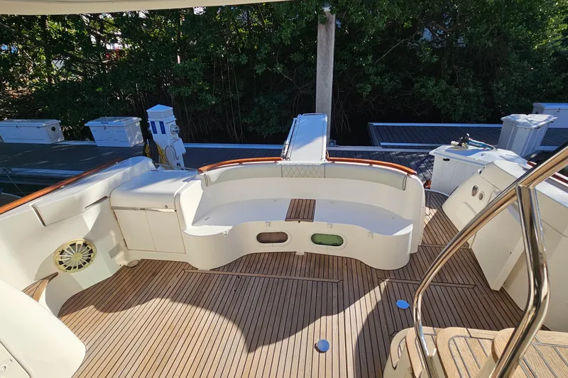 Slide: The Image of 2005 Prestige 46 yacht cruising near city skyline on calm water. - 9