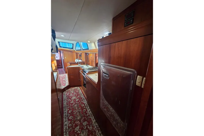 Slide: The Image of Interior of 1998 Oyster 485 Deck Saloon yacht with wood finish and modern amenities. - 15