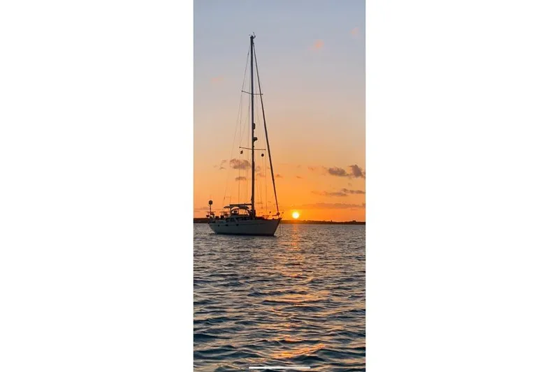 Slide: The Image of Sailboat Oyster 485 Deck Saloon 1998 at sunset on calm waters. - 2