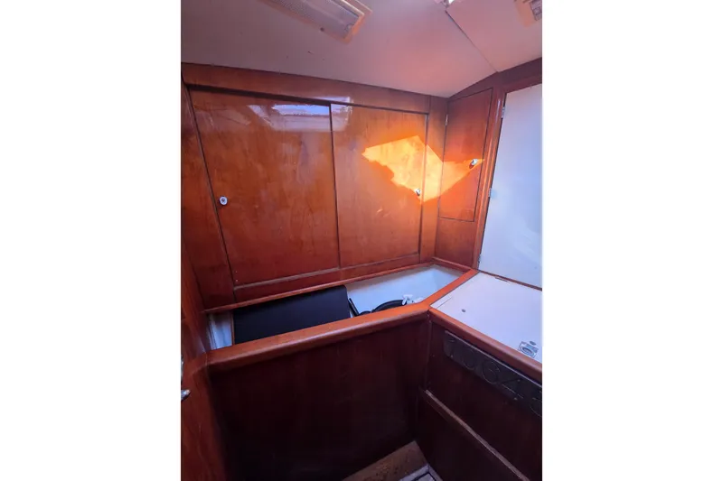 Slide: The Image of Interior of 1998 Oyster 485 Deck Saloon with wooden paneling and skylight. - 25