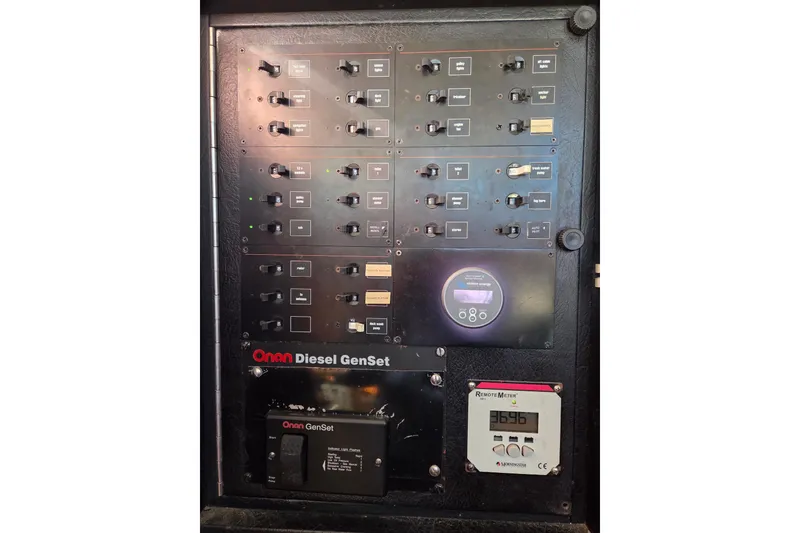 Slide: The Image of Control panel of a 1998 Oyster 485 Deck Saloon yacht with switches and meters. - 34