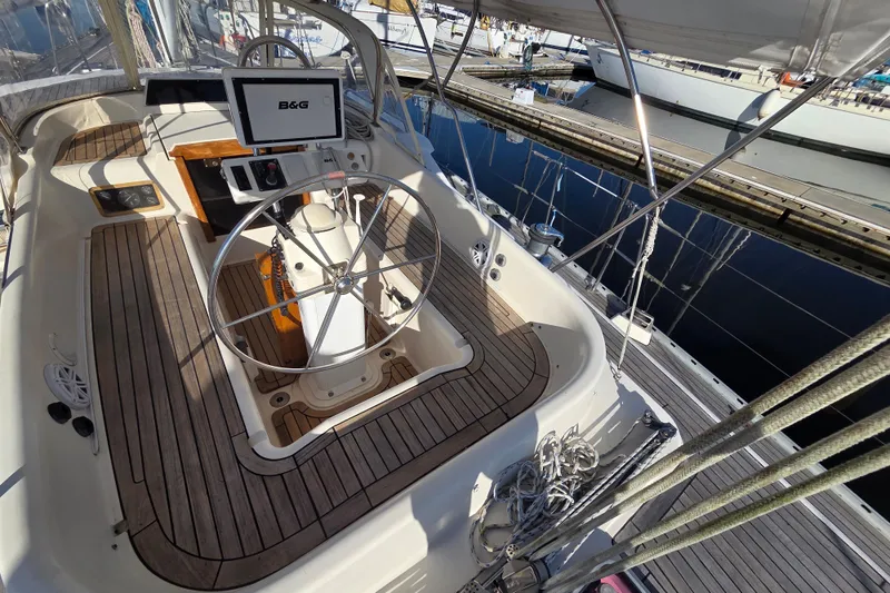 Slide: The Image of Cockpit of 1998 Oyster 485 Deck Saloon yacht with wooden flooring and steering wheel. - 43