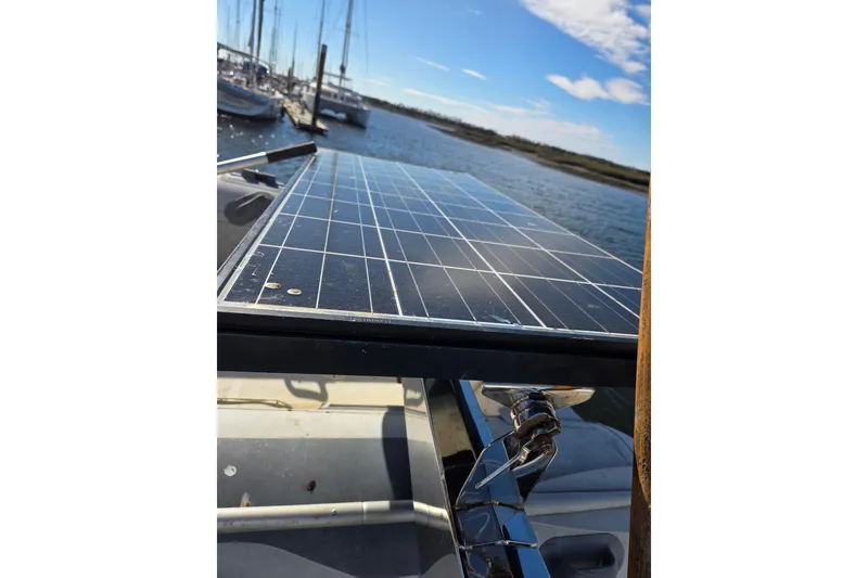 Slide: The Image of Moored Oyster 485 Deck Saloon yacht with dinghy and Yamaha motor in sunny marina. - 54