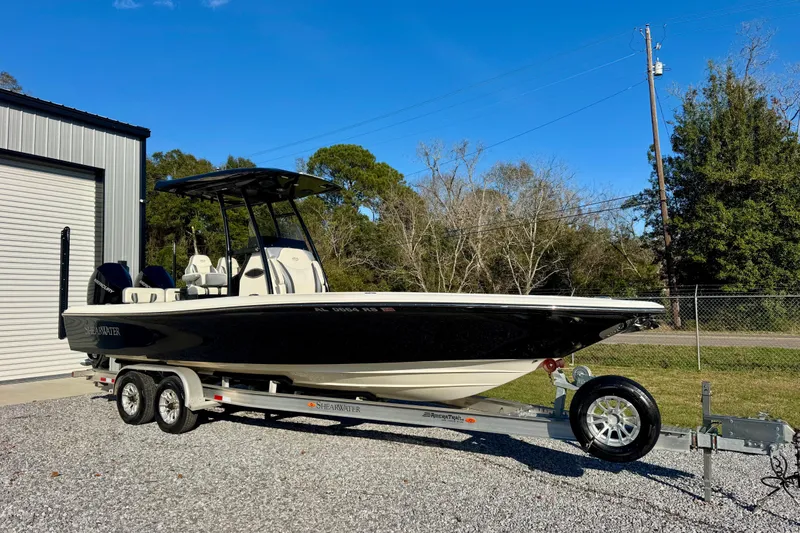 The Image of 2021 ShearWater 27 Carolina boat on trailer, parked outdoors near a building. - 1
