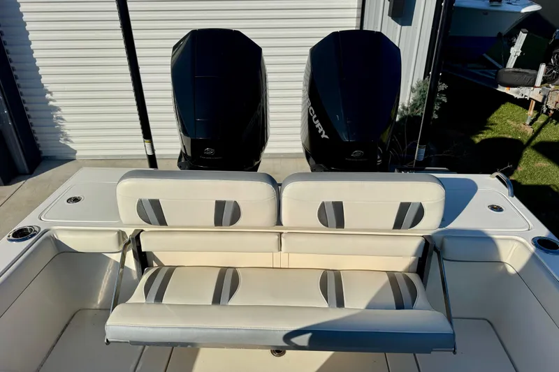 Slide: The Image of 2021 ShearWater 27 Carolina boat with dual Mercury engines and cushioned seating. - 11