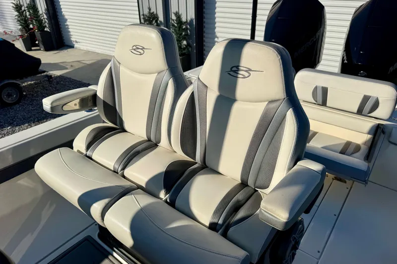 Slide: The Image of 2021 ShearWater 27 Carolina boat seats with armrests, featuring sleek design and comfortable upholstery. - 12